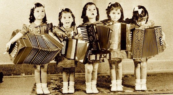 Five young girls playing accordions together, early Accordion Sisters starting their musical journey