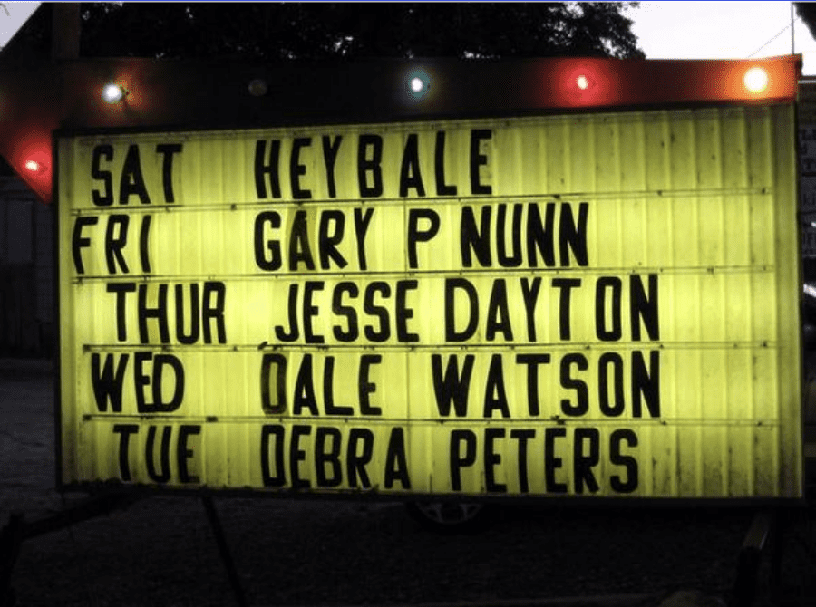 Broken Spoke marquee sign at night featuring Debra Peters, Dale Watson, Jesse Dayton, Gary P Nunn and Heybale in Austin, Texas

