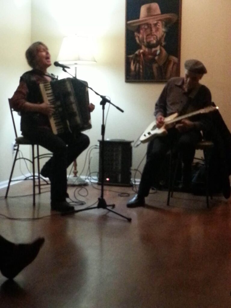 Singing and playing accordion with Jhan Dudley at a house concert of Cliff Morrison