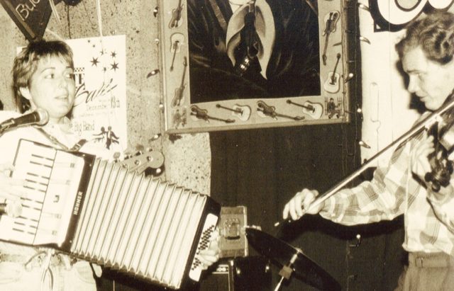 Young Debra Peters playing accordion with violinist Erik Hokkanen in an early performance at the Continental Club in Austin Texas