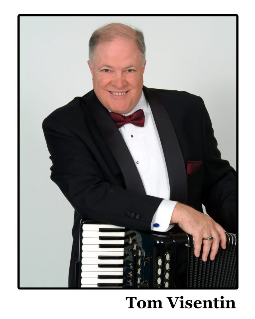 Ship Captain Tom Visentin smiling while holding his accordion