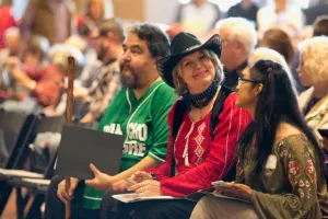 Debra Peters in red shirt and black hat enjoying judging the Texas Folklife Big Squeeze accordion contest 2018